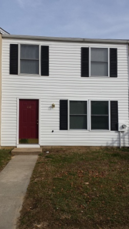 white 2 story townhouse with red door