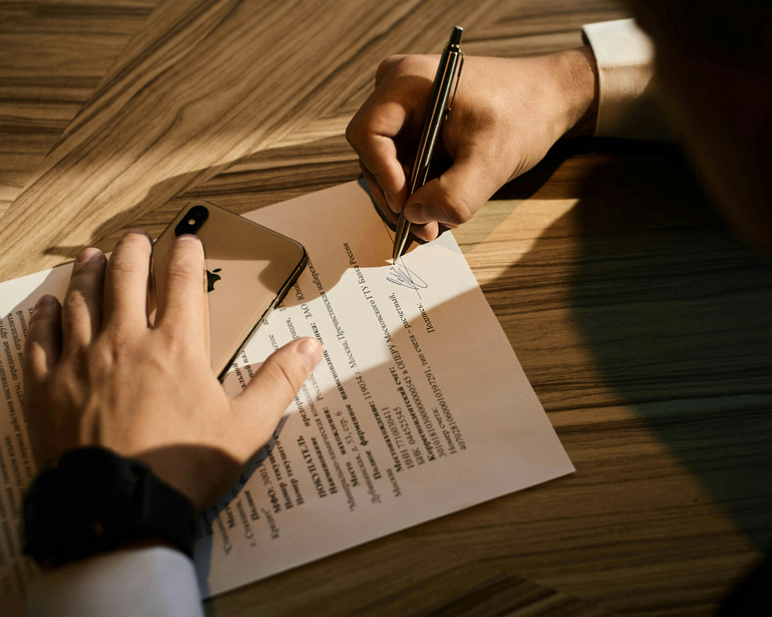 picture of a paper application with a person signing it